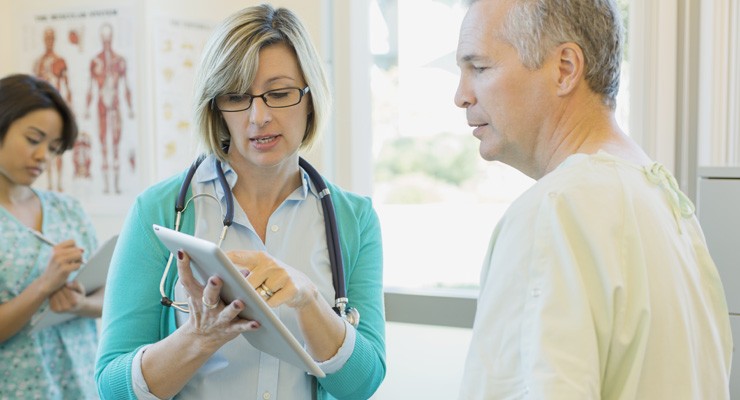 nurse reviewing a chart with a male patient